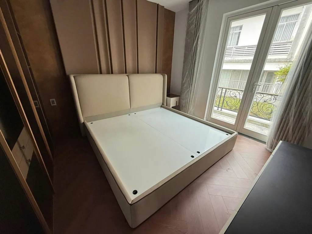 Phòng ngủ biệt thự Saroma Sala Thủ Thiêm với giường bọc nệm cao cấp và ban công hướng vườn. 